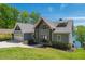 Inviting craftsman-style home with a two-car garage, stone accents, and lush green lawn at 5635 Cherokee Trce, Cumming, GA 30041