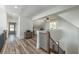Upstairs hallway with wood-look flooring, iron railing, and a view of a study with natural light at 5635 Cherokee Trce, Cumming, GA 30041