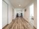 Hallway showcasing wood floors, white walls, and a view of a room with arcade games at 5635 Cherokee Trce, Cumming, GA 30041