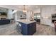 Kitchen with a blue island, stainless steel appliances, and views into the living area at 5635 Cherokee Trce, Cumming, GA 30041