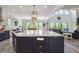 Open concept kitchen with a large island, stainless steel appliances, and view of the living area at 5635 Cherokee Trce, Cumming, GA 30041