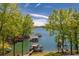 Picturesque lake view with boat docks surrounded by lush greenery and clear blue skies at 5635 Cherokee Trce, Cumming, GA 30041