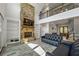 This elegant living room features a stone fireplace, built-in bookshelves, and a comfortable seating area at 5635 Cherokee Trce, Cumming, GA 30041