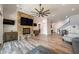 Living room featuring a stone fireplace, large windows, and hardwood floors at 5635 Cherokee Trce, Cumming, GA 30041