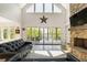 This elegant living room boasts a stone fireplace, large windows and sliding doors that provide natural light and stunning views at 5635 Cherokee Trce, Cumming, GA 30041