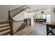 Open-concept living area with staircase features hardwood floors, lake views, and a cozy atmosphere at 5635 Cherokee Trce, Cumming, GA 30041
