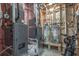 Mechanical room with water heaters, HVAC equipment, and visible wiring at 5635 Cherokee Trce, Cumming, GA 30041