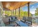 Spacious covered porch boasts lake views and comfortable outdoor seating area at 5635 Cherokee Trce, Cumming, GA 30041