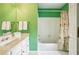 Bright bathroom with white vanity, and a tub with shower at 1016 Lenox Ne Crst, Atlanta, GA 30324