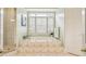 Bright bathroom features a jacuzzi tub with tile surround and a glass shower door at 1016 Lenox Ne Crst, Atlanta, GA 30324