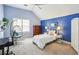 Bright bedroom with blue accent wall, hanging chair, and plush carpet flooring at 1016 Lenox Ne Crst, Atlanta, GA 30324