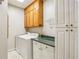 Well-lit laundry room features built-in cabinets, washer, dryer, and a green countertop for folding clothes at 1016 Lenox Ne Crst, Atlanta, GA 30324