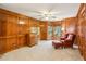 Classic living room with rich wood paneling, bay window, and comfortable seating area with chair and ottoman at 1016 Lenox Ne Crst, Atlanta, GA 30324