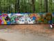 Artistic mural in a wooded area, featuring assorted paintings with a mulch ground covering at 1016 Lenox Ne Crst, Atlanta, GA 30324