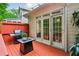 Cozy outdoor patio with a grill, table, and access to the home through elegant French doors at 1016 Lenox Ne Crst, Atlanta, GA 30324