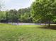 Outdoor tennis court, surrounded by lush greenery, offers a perfect place for recreation and fitness at 1016 Lenox Ne Crst, Atlanta, GA 30324