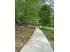 Scenic paved walking path lined with mature trees, perfect for leisurely strolls and enjoying nature at 1016 Lenox Ne Crst, Atlanta, GA 30324