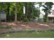 This backyard features many mature shade trees and is partially fenced at 40 Templeton Ln, Villa Rica, GA 30180