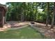 Large backyard featuring a fire pit and trees at 40 Templeton Ln, Villa Rica, GA 30180