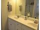 Bathroom featuring a double sink vanity with white cabinets and a large mirror, plus a glass-enclosed shower and visible decor at 40 Templeton Ln, Villa Rica, GA 30180