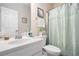 Bathroom featuring a single sink vanity and a toilet with mint green shower curtain at 40 Templeton Ln, Villa Rica, GA 30180