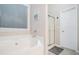 A bright bathroom featuring a soaking tub and a separate shower at 40 Templeton Ln, Villa Rica, GA 30180