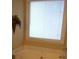 Bright bathroom featuring a soaking tub with tile surround and a large window with blinds for natural light and privacy at 40 Templeton Ln, Villa Rica, GA 30180