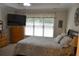 Bright bedroom with a large window, a ceiling fan, and a queen bed with a patterned comforter in a neutral color scheme at 40 Templeton Ln, Villa Rica, GA 30180