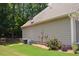 Side view of a beige house with well maintained green grass and shrubbery at 40 Templeton Ln, Villa Rica, GA 30180
