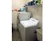 Bright laundry room featuring side by side washer and dryer and shelving above at 40 Templeton Ln, Villa Rica, GA 30180