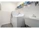 Laundry room equipped with a washer, dryer, sink, and storage shelf at 40 Templeton Ln, Villa Rica, GA 30180