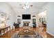 Cozy living room with hardwood floors, fireplace, and large windows at 40 Templeton Ln, Villa Rica, GA 30180