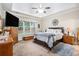 Cozy main bedroom featuring a tray ceiling, neutral colors, and a large window at 40 Templeton Ln, Villa Rica, GA 30180