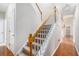 Carpeted staircase featuring white risers, and a stained railing at 40 Templeton Ln, Villa Rica, GA 30180
