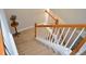 Carpeted staircase with white risers and stained railing leading upstairs at 40 Templeton Ln, Villa Rica, GA 30180