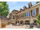 Beautiful building featuring outdoor BBQ area with seating, and an archway leading to an outdoor lounge at 200 River Vista Dr # 401, Atlanta, GA 30339