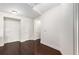 Entry hallway featuring hardwood floors, neutral walls, and storage space at 200 River Vista Dr # 401, Atlanta, GA 30339