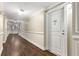 Hallway featuring elegant trim work and wood flooring leading to unit 401 at 200 River Vista Dr # 401, Atlanta, GA 30339