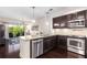 Modern kitchen featuring stainless steel appliances, granite counters, and dark wood cabinetry at 200 River Vista Dr # 401, Atlanta, GA 30339