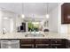 Kitchen island featuring granite countertops and stainless steel appliances flowing into the living area and balcony at 200 River Vista Dr # 401, Atlanta, GA 30339