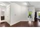 Bright living room showcasing hardwood floors and access to the bathroom and balcony view at 200 River Vista Dr # 401, Atlanta, GA 30339