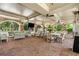 Covered outdoor lounge featuring comfortable seating, ceiling fans, a TV, and a brick patio for relaxation at 200 River Vista Dr # 401, Atlanta, GA 30339
