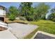 Beautiful backyard with a gravel seating area, lush greenery, and mature trees at 2015 Cascade Sw Rd, Atlanta, GA 30311