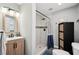 Modern bathroom features a tiled walk-in shower and wood vanity with black hardware at 2015 Cascade Sw Rd, Atlanta, GA 30311