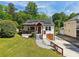 Charming home with a well-manicured lawn, a cozy porch, and solar panels at 2015 Cascade Sw Rd, Atlanta, GA 30311