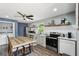 Well-equipped kitchen with gray cabinets, modern appliances, and an adjacent dining area for easy meals at 2015 Cascade Sw Rd, Atlanta, GA 30311