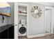 Convenient laundry area with modern washing machine, storage shelves, and stylish decorative mirror at 2015 Cascade Sw Rd, Atlanta, GA 30311