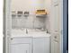 Functional laundry area with washer, dryer, and storage shelving for added convenience at 2015 Cascade Sw Rd, Atlanta, GA 30311