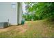 Home exterior with green lawn, patio and woods in the background at 3777 Oakland Spring Ct, Snellville, GA 30039