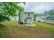 Home exterior with a landscaped backyard, patio, and green trash cans at 3777 Oakland Spring Ct, Snellville, GA 30039